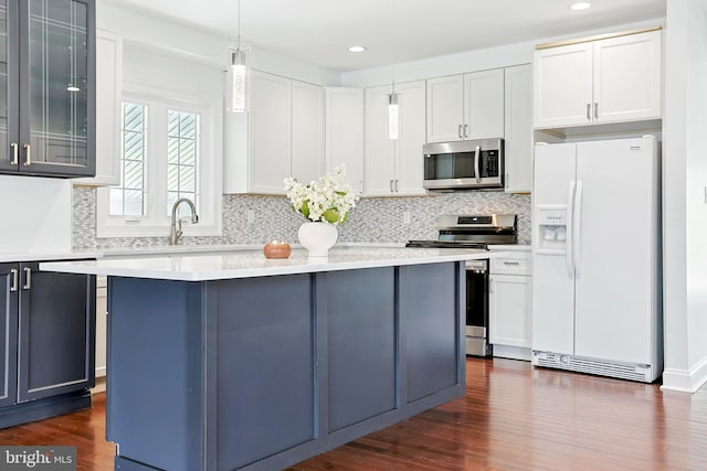 228 Warren Blvd, Broomall, PA 19008 - kitchen with appliances with stainless steel finishes, light countertops, recessed lighting, a center island, and decorative light fixtures