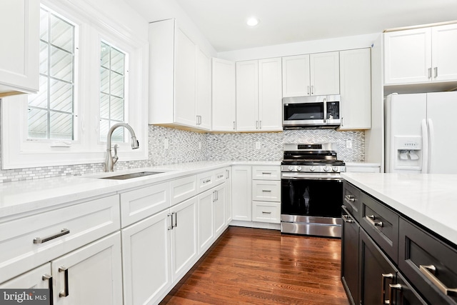 228 Warren Blvd, Broomall, PA 19008 - kitchen featuring appliances with stainless steel finishes, white cabinets, tasteful backsplash, dark wood finished floors, and recessed lighting