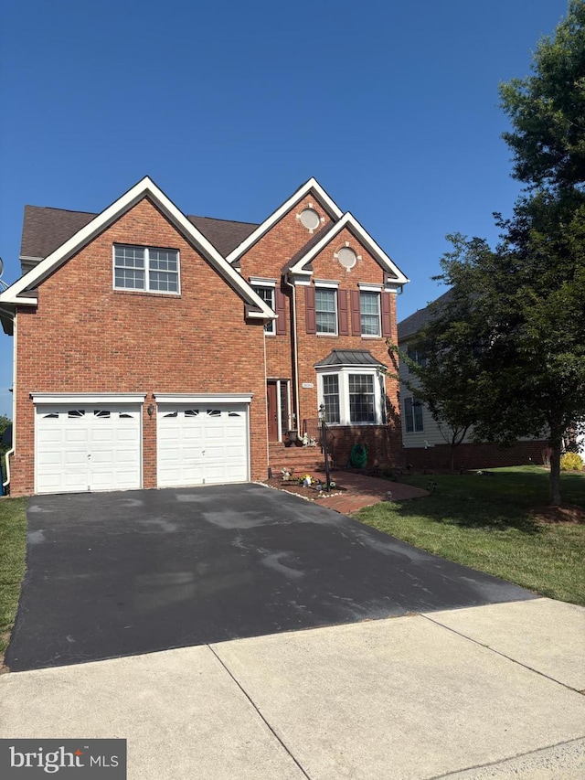 20385 Medalist Dr, Ashburn, VA 20147 - traditional home with driveway, brick siding, and an attached garage