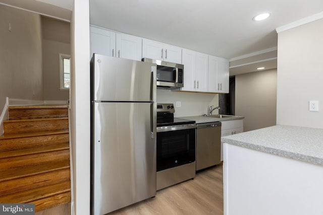136 Chadwick Ave, Linwood, PA 19061 - kitchen featuring stainless steel appliances, white cabinets, light wood finished floors, light countertops, and recessed lighting
