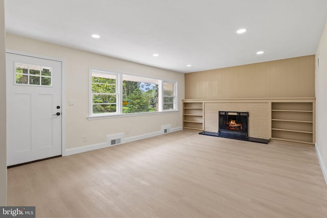 19 Glen Stewart Dr, Ewing, NJ 08618 - unfurnished living room featuring plenty of natural light, wood finished floors, recessed lighting, a brick fireplace, and wood walls