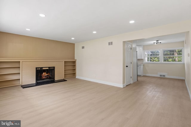 19 Glen Stewart Dr, Ewing, NJ 08618 - unfurnished living room with light wood finished floors, a brick fireplace, and recessed lighting