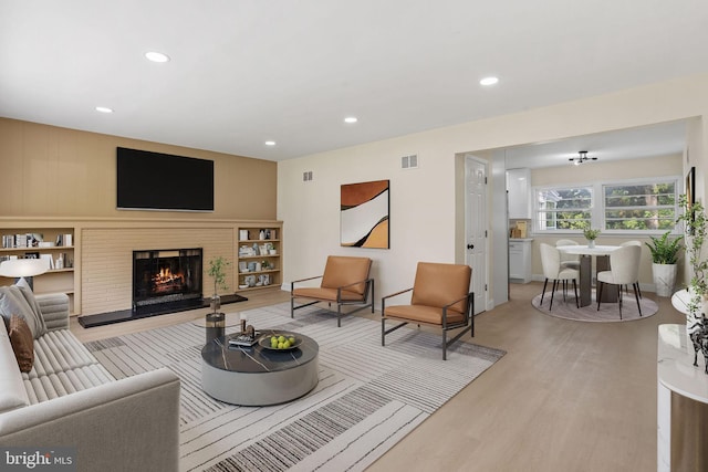 19 Glen Stewart Dr, Ewing, NJ 08618 - living room with light wood-style flooring, recessed lighting, and a warm lit fireplace