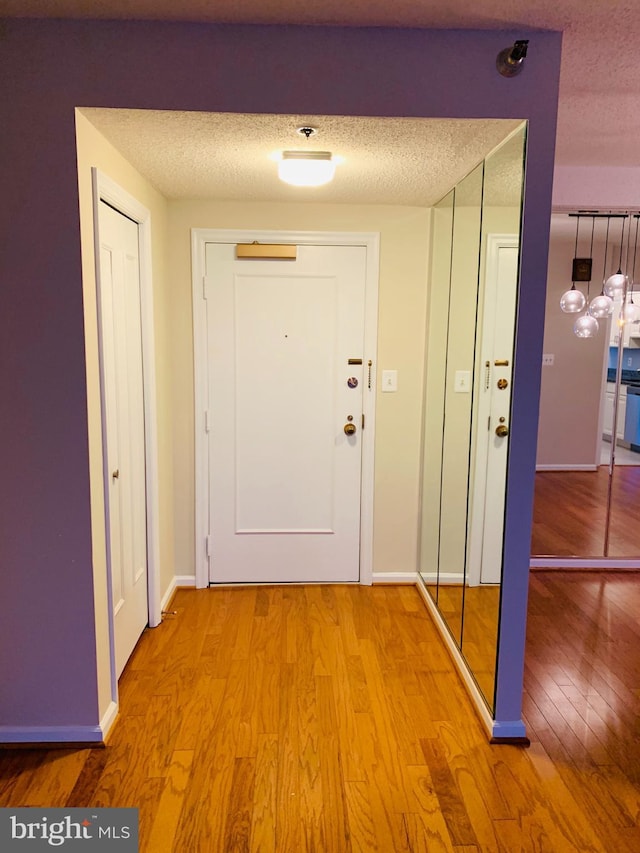 5800 Nicholson Ln Unit 1-908, Rockville, MD 20852 - hallway with light wood-style flooring and a textured ceiling
