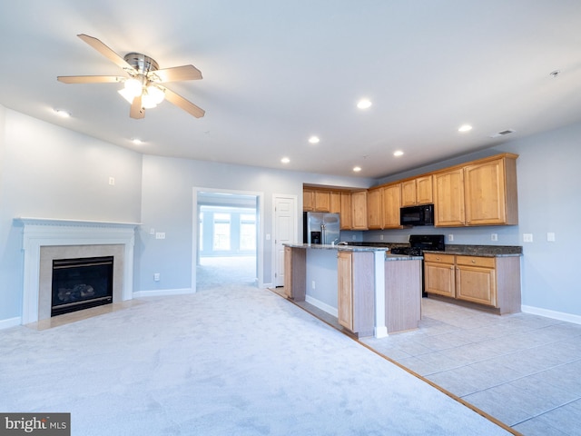 591 Odendhal Ave Unit 591, Gaithersburg, MD 20877 - kitchen with black microwave, stainless steel fridge with ice dispenser, range with gas stovetop, recessed lighting, and a kitchen island with sink
