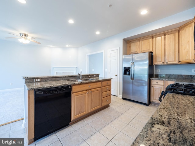 591 Odendhal Ave Unit 591, Gaithersburg, MD 20877 - kitchen with black appliances, light tile patterned floors, dark stone countertops, light brown cabinetry, and a ceiling fan