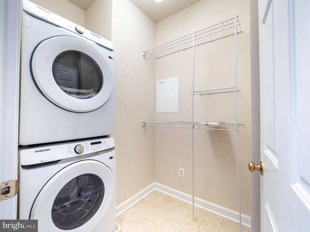 591 Odendhal Ave Unit 591, Gaithersburg, MD 20877 - washroom featuring stacked washer / dryer and baseboards