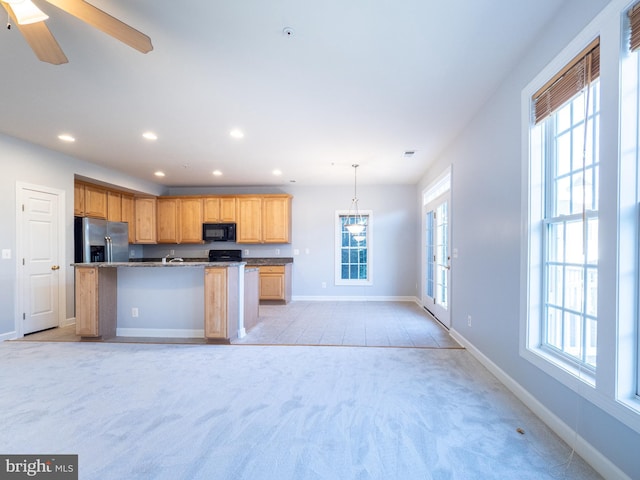 591 Odendhal Ave Unit 591, Gaithersburg, MD 20877 - kitchen with stainless steel fridge, black microwave, light colored carpet, open floor plan, and recessed lighting