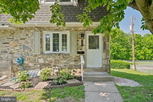 805 Windsor Cir, Folcroft, PA 19032 - view of exterior entry with stone siding, roof with shingles, and mansard roof