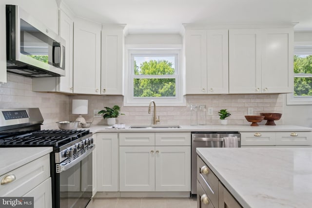 805 Windsor Cir, Folcroft, PA 19032 - kitchen featuring stainless steel appliances, white cabinetry, and tasteful backsplash