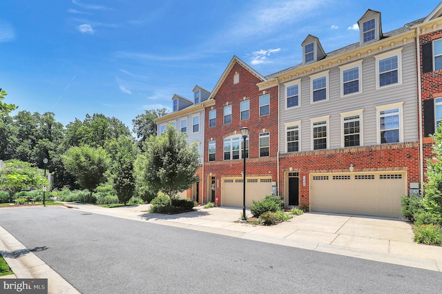 1025 Mutual Pl, Sandy Spring, MD 20860 - view of property with brick siding, a garage, and driveway