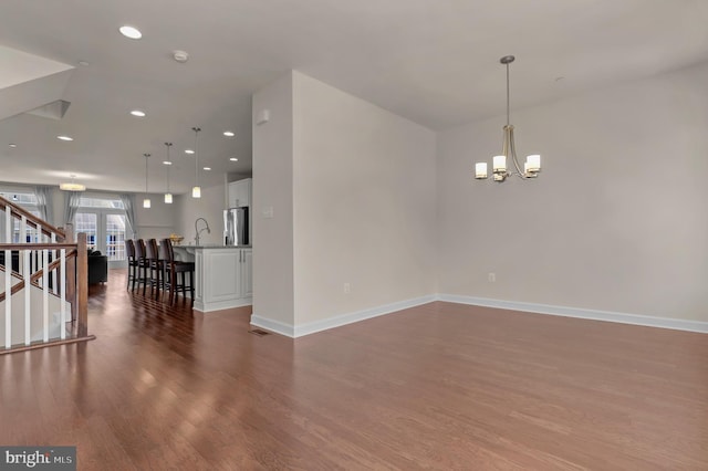 1025 Mutual Pl, Sandy Spring, MD 20860 - spare room with wood finished floors, stairs, a chandelier, recessed lighting, and a smoke detector