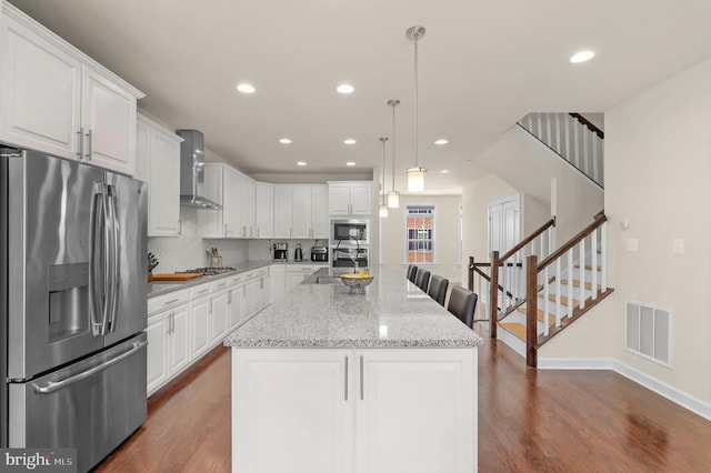 1025 Mutual Pl, Sandy Spring, MD 20860 - kitchen featuring stainless steel appliances, wall chimney exhaust hood, dark wood-style floors, white cabinets, and recessed lighting