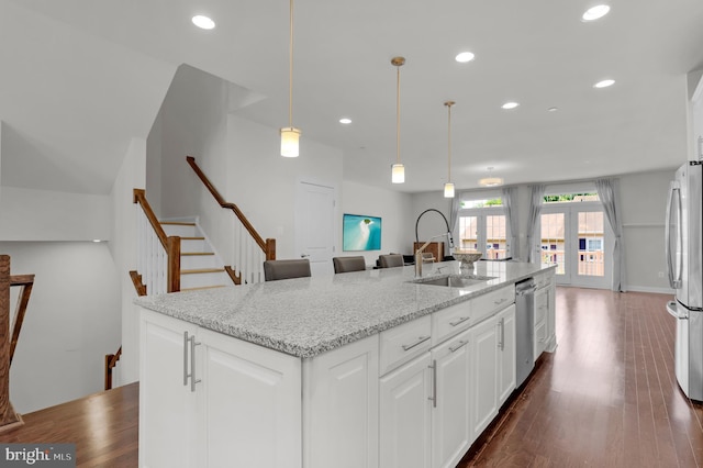 1025 Mutual Pl, Sandy Spring, MD 20860 - kitchen with stainless steel appliances, recessed lighting, white cabinetry, a kitchen island with sink, and light stone counters