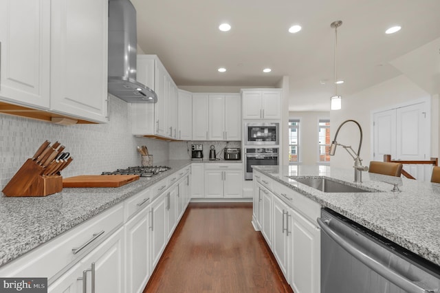 1025 Mutual Pl, Sandy Spring, MD 20860 - kitchen featuring wall chimney range hood, stainless steel appliances, dark wood-style floors, white cabinets, and recessed lighting