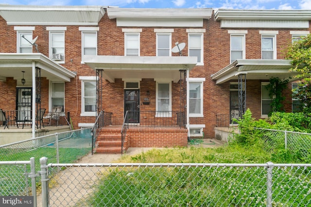 1816 Chilton St, Baltimore, MD 21218 - multi unit property featuring covered porch, a gate, a fenced front yard, and brick siding
