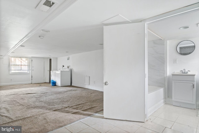 1816 Chilton St, Baltimore, MD 21218 - unfurnished room featuring washer / clothes dryer and light tile patterned flooring