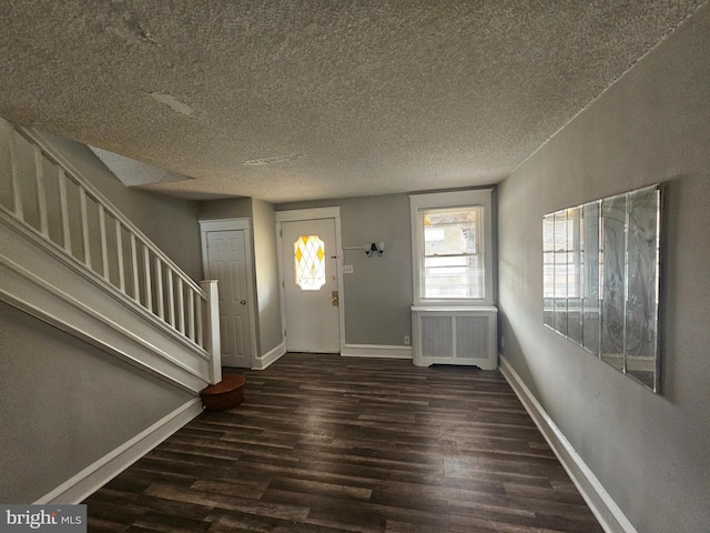 3902 Howland St, Philadelphia, PA 19124 - foyer entrance featuring wood finished floors, radiator, stairs, and a textured ceiling