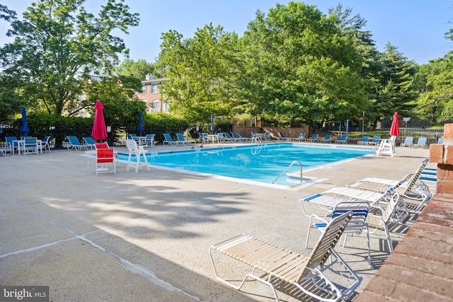 8 Cheverny Ct, Hamilton, NJ 08619 - community pool with a patio and view of wooded area