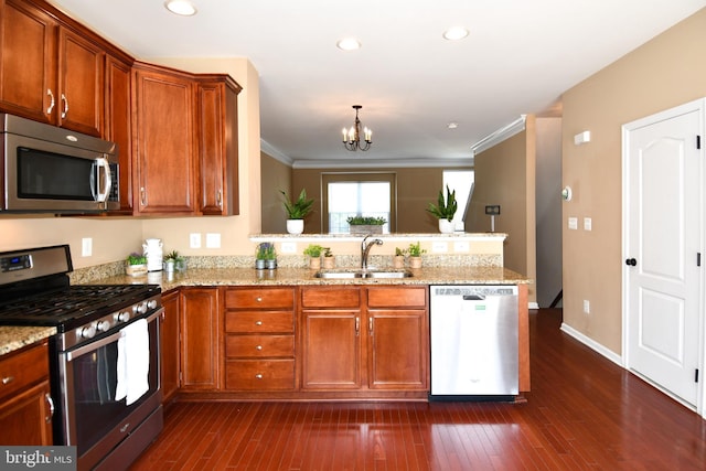 42825 Pamplin Ter, Chantilly, VA 20152 - kitchen with appliances with stainless steel finishes, a peninsula, a chandelier, light stone countertops, and crown molding