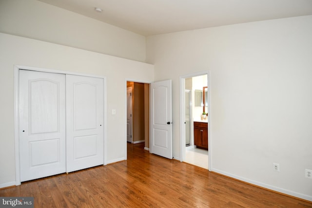 42825 Pamplin Ter, Chantilly, VA 20152 - unfurnished bedroom with a closet, wood finished floors, lofted ceiling, and ensuite bathroom