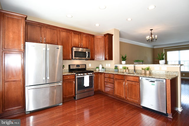 42825 Pamplin Ter, Chantilly, VA 20152 - kitchen featuring stainless steel appliances, a peninsula, dark wood finished floors, a chandelier, and light stone countertops