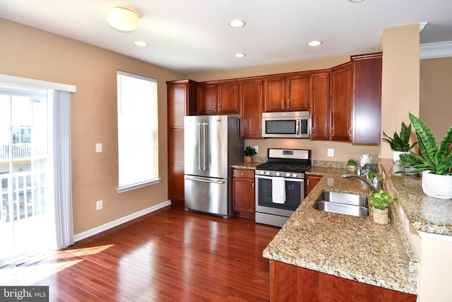 42825 Pamplin Ter, Chantilly, VA 20152 - kitchen featuring appliances with stainless steel finishes, light stone countertops, dark wood finished floors, recessed lighting, and brown cabinetry