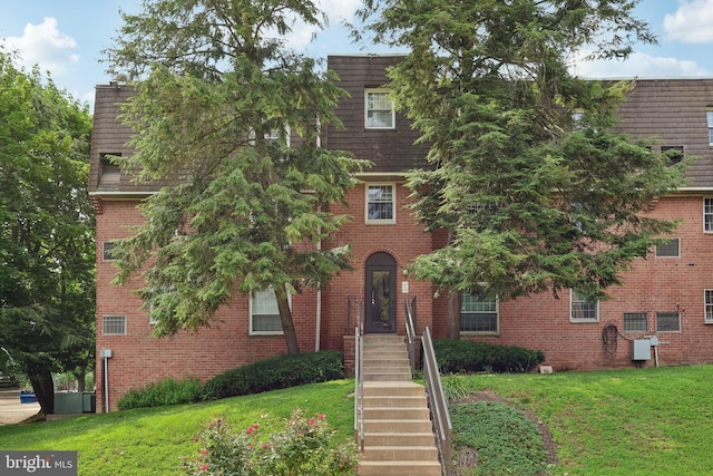 4000 Gypsy Ln Unit 529, Philadelphia, PA 19129 - view of front of property with a front lawn, mansard roof, and brick siding