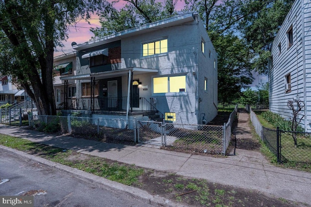 1579 S 8th St, Camden, NJ 08104 - townhome / multi-family property with a gate, a fenced front yard, and covered porch