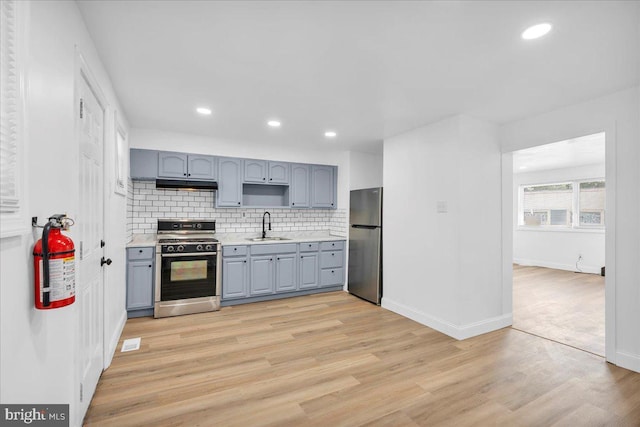 1579 S 8th St, Camden, NJ 08104 - kitchen featuring range with gas stovetop, freestanding refrigerator, gray cabinets, light countertops, and tasteful backsplash