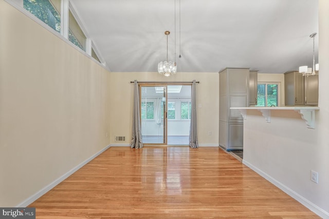 5606 Eastbourne Dr, Springfield, VA 22151 - unfurnished dining area featuring healthy amount of natural light, light wood finished floors, a chandelier, and lofted ceiling