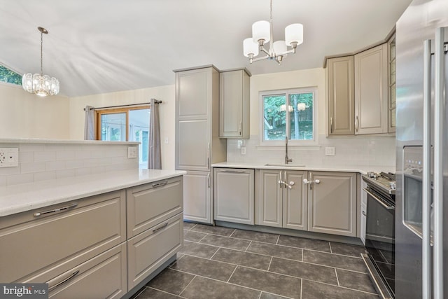 5606 Eastbourne Dr, Springfield, VA 22151 - kitchen featuring a chandelier, stainless steel fridge, black gas range, and dark tile patterned floors