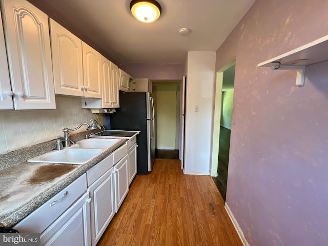 67 Bruce Park Dr, Trenton, NJ 08618 - kitchen with white cabinetry, wood finished floors, decorative backsplash, and freestanding refrigerator