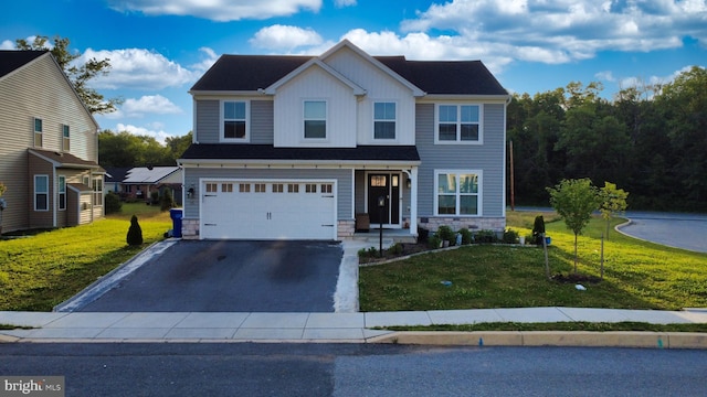 15 Long Bend Dr, Carlisle, PA 17015 - view of front facade with stone siding, asphalt driveway, a front lawn, a garage, and board and batten siding