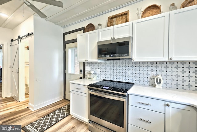 137 S E St, Spring Grove, PA 17362 - kitchen featuring appliances with stainless steel finishes, tasteful backsplash, light wood-style floors, and light countertops