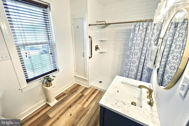 137 S E St, Spring Grove, PA 17362 - bathroom with healthy amount of natural light, a tile shower, vanity, and wood finished floors