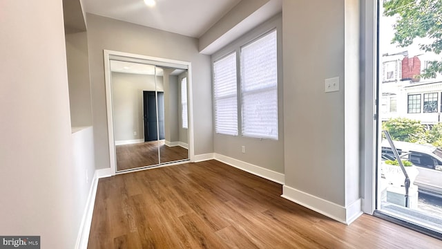 5841 Cedarhurst St, Philadelphia, PA 19143 - unfurnished bedroom with access to exterior, wood finished floors, and multiple windows