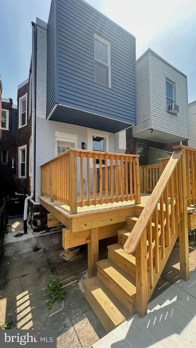 5841 Cedarhurst St, Philadelphia, PA 19143 - rear view of house featuring brick siding, a deck, cooling unit, and stairway