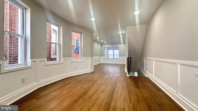5841 Cedarhurst St, Philadelphia, PA 19143 - unfurnished room featuring wood finished floors, wainscoting, and a decorative wall