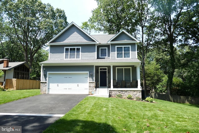 207 Beverley Ave, Edgewater, MD 21037 - craftsman-style house featuring asphalt driveway, an attached garage, stone siding, and a porch