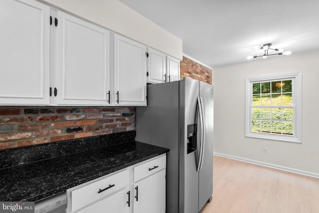 8384 Forrester Blvd, Springfield, VA 22152 - kitchen with stainless steel fridge with ice dispenser, white cabinets, light wood-style flooring, and dark stone countertops