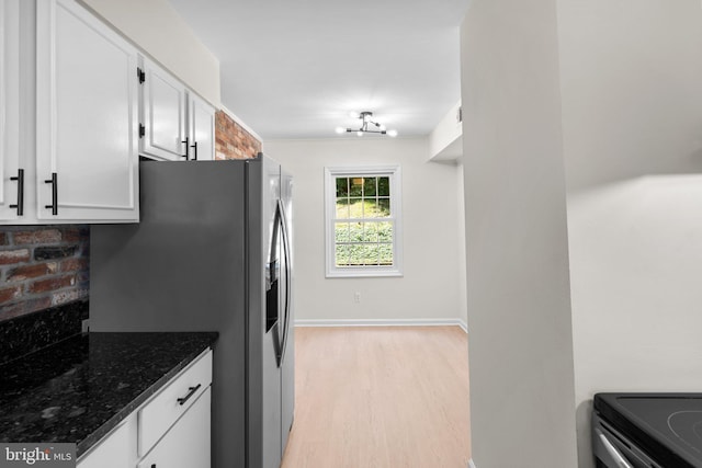 8384 Forrester Blvd, Springfield, VA 22152 - kitchen with stainless steel fridge, light wood-style floors, white cabinets, dark stone counters, and electric range oven