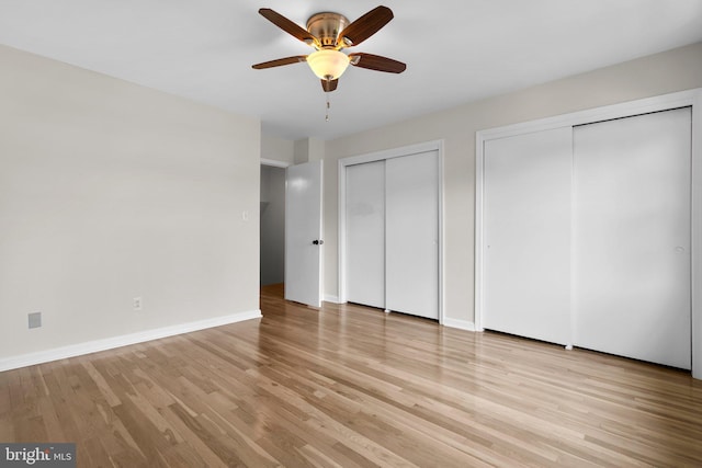 8384 Forrester Blvd, Springfield, VA 22152 - unfurnished bedroom with multiple closets, light wood-style flooring, and ceiling fan