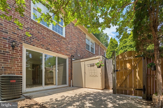 8384 Forrester Blvd, Springfield, VA 22152 - back of property featuring brick siding, a gate, and a patio