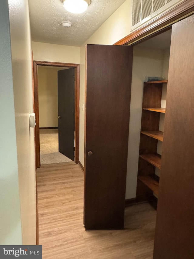 23311 Sugar Maple Ct Unit 1, California, MD 20619 - hallway featuring light wood finished floors and a textured ceiling