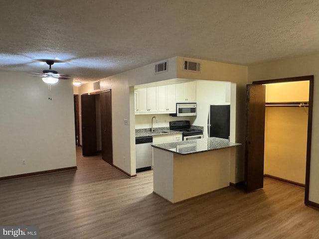 23311 Sugar Maple Ct Unit 1, California, MD 20619 - kitchen with stainless steel appliances, a textured ceiling, wood finished floors, white cabinets, and a ceiling fan