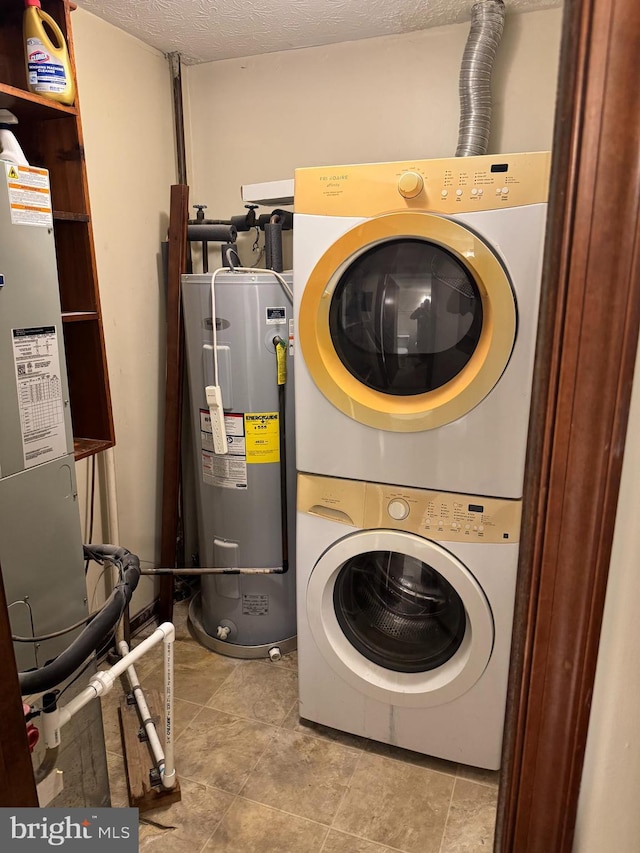 23311 Sugar Maple Ct Unit 1, California, MD 20619 - washroom featuring stacked washer / dryer, electric water heater, and a textured ceiling