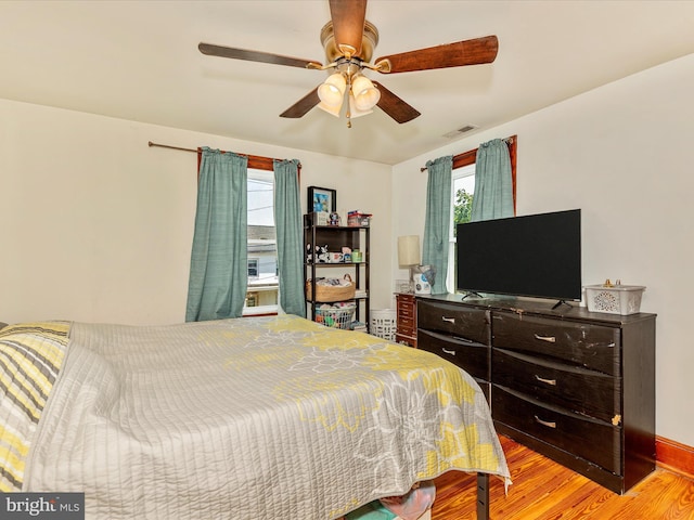 21127 Twin Springs Dr, Smithsburg, MD 21783 - bedroom featuring multiple windows, light wood-style flooring, and ceiling fan