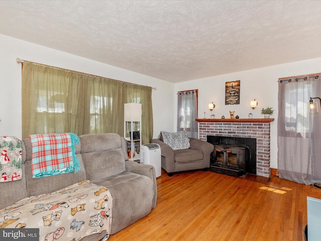 21127 Twin Springs Dr, Smithsburg, MD 21783 - living area with wood finished floors, a fireplace, and a textured ceiling