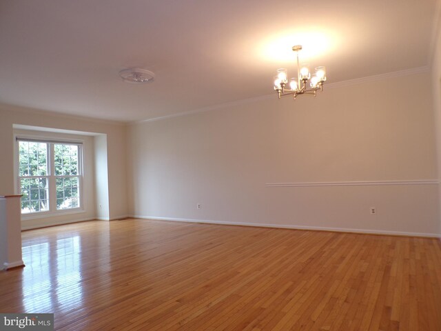 44035 Kings Arms Sq, Ashburn, VA 20147 - spare room with a chandelier, crown molding, and light wood-type flooring